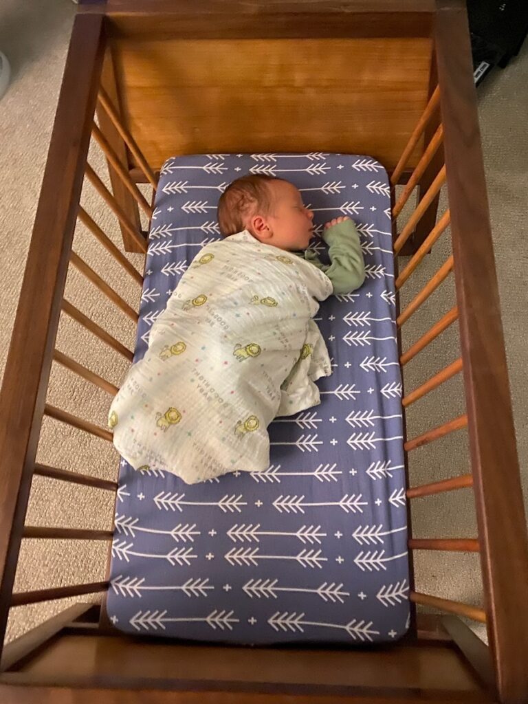 Photo of Theo in bassinet