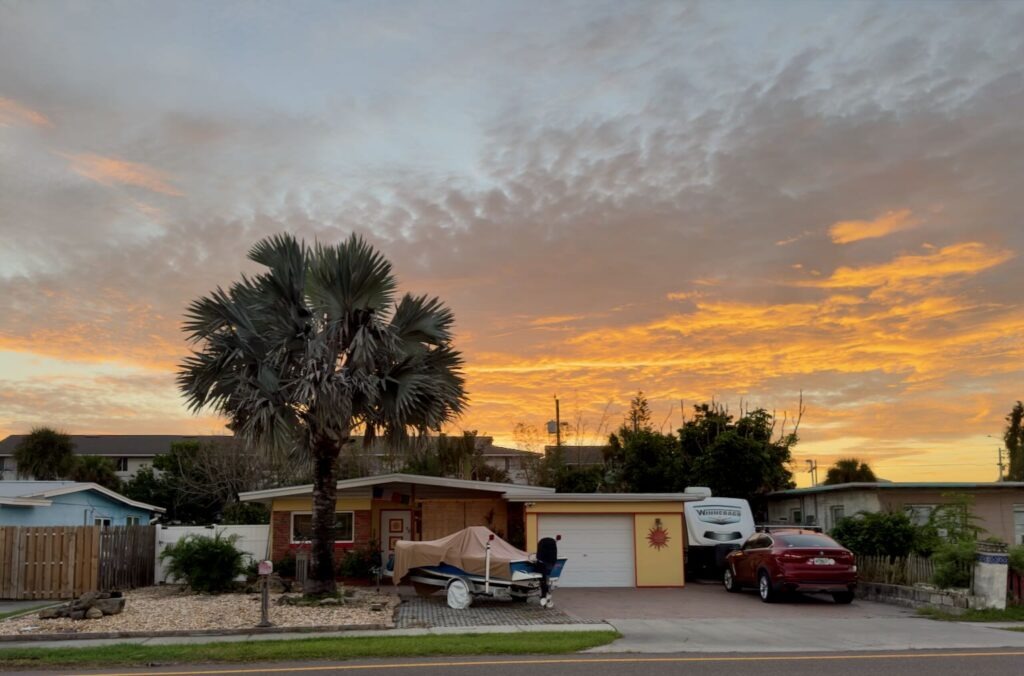 Picture of my house with a sunrise behind it